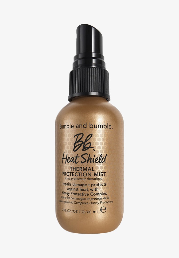 Bumble and bumble Heat Shield, flacon vaporisateur de 60 ml avec une finition dorée métallique, un bouchon de pompe noir et un motif hexagonal. Contient une formule de protection thermique.