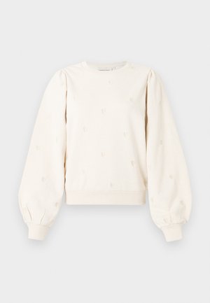 Felpa color crema con maniche a sbuffo, polsini a coste e motivi a cuore ricamati in tutto il capo. Tessuto di cotone morbido con vestibilità comoda.