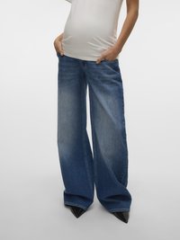 Wide-leg blue denim jeans with a faded effect, featuring pockets and a high waist, paired with pointed black heels.