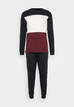 Long-sleeve pajama set featuring a black, white, and burgundy color block design. Made of soft cotton, with elastic cuffs and waistband.