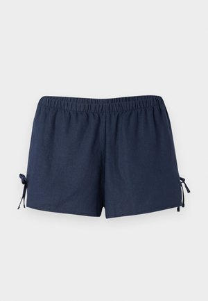 Tengerészkék rövidnadrág, rugalmas derékkal és állítható kötőkkel az oldalán. Az anyaga simának tűnik, enyhe fényes hatással. Laza szabású, térd felett.