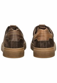 Brown suede sneakers with a textured finish, featuring a tan rubber sole and subtle branding at the heel. Rounded toe and rear loop.