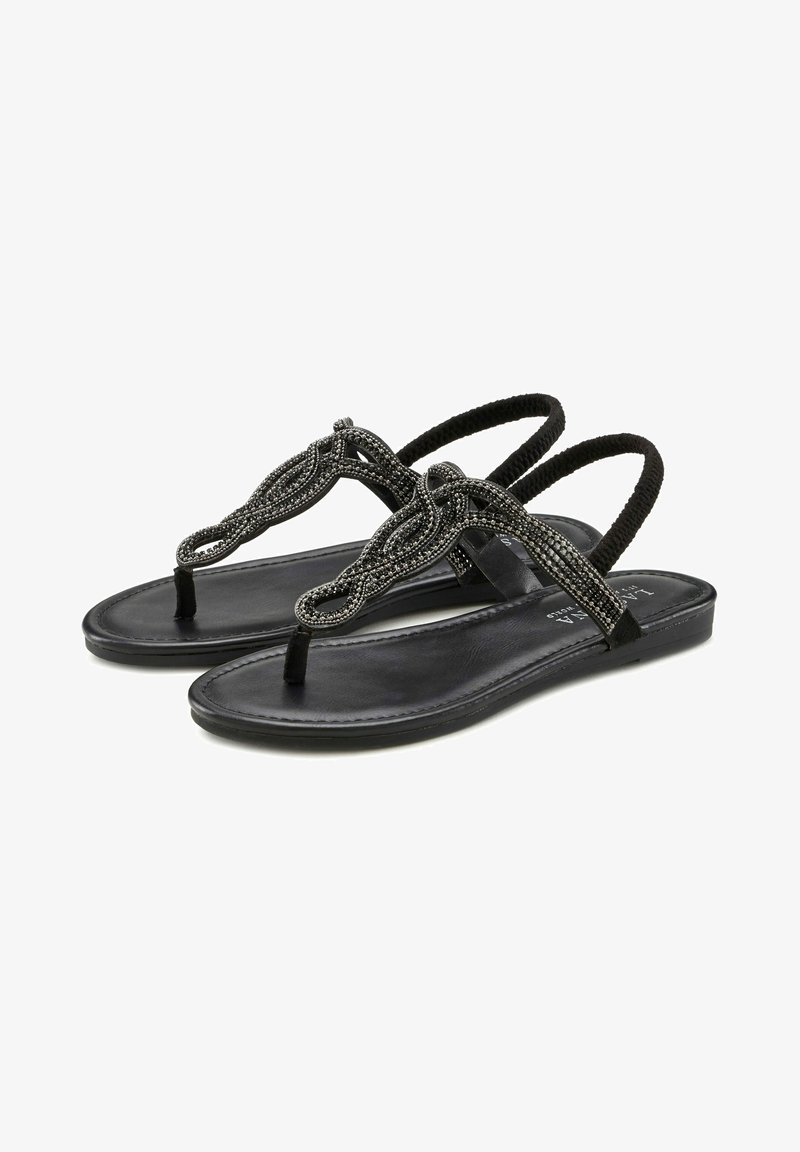 Black sandals with a flat sole, featuring decorative beaded straps and a toe post design. The straps are intricately woven, offering a textured detail.