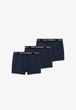Trois boxers bleu marine pour hommes avec des bandes noires à la taille ornées du logo blanc "KARL LAGERFELD", disposés en rangée décalée.