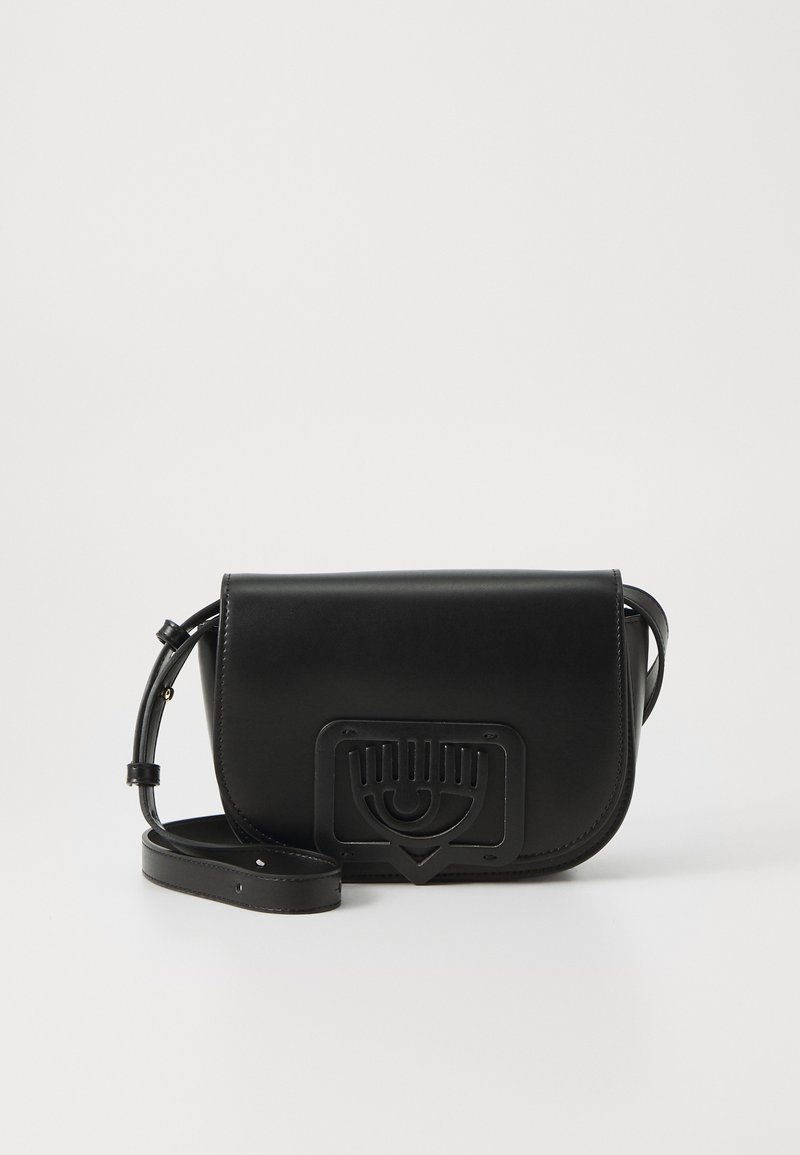 Black leather crossbody bag with a smooth finish, a triangular closure, and a prominent eye motif on the front. Adjustable strap included.