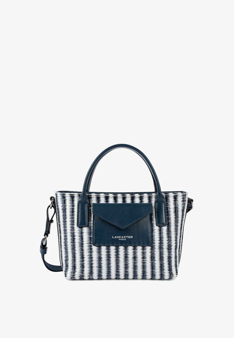 Sac à main tissé bleu marine et blanc avec doubles poignées, poche avant en cuir bleu marine avec rabat en forme d'enveloppe, et bandoulière réglable.