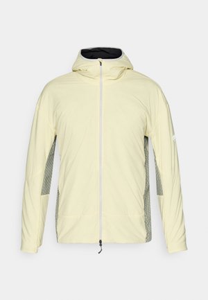 Veste jaune clair avec une capuche, dotée de panneaux latéraux en maille grise et d'une fermeture éclair à l'avant, fabriquée en tissu doux et léger.