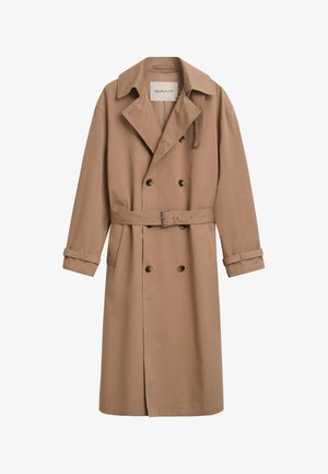 Helepruun trench coat, millel on topeltkinnitatud disain, lai krae ja vööga vöökoht. Valmistatud siledast kangast, millel on nööpkaunistused.