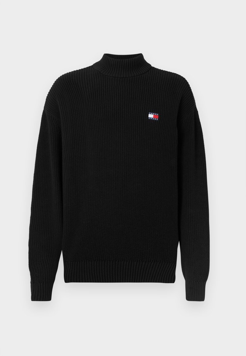 Zwarte gebreide turtleneck trui met ribbeltextuur en een ontspannen pasvorm. Bevat een klein, kleurrijk logo-embleem op de linkerborst.