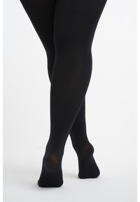 Zwarte ondoorzichtige maillots met een gladde textuur, voorzien van verstevigde hiel- en teen details, en een aansluitende pasvorm die zich aan de benen vormt.