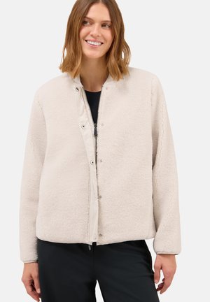 Hellbeige Fleecejacke mit glattem Innenfutter, Druckknöpfen und lässiger Passform. Weiche Textur und lange Ärmel ohne sichtbare Muster.