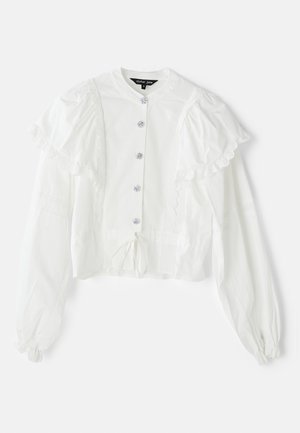 White blouse with puff sleeves, frill accents, and five decorative buttons. Features a tie at the waist and light textured fabric.