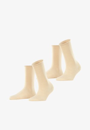 Beige Baumwollsocken in Mid-Calf-Länge mit glatter Textur und elastischen Bündchen. Vier Paare werden angezeigt, die eine einheitliche Form und Farbe aufweisen.