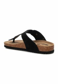 Chancla de ante negra con suela de corcho, que presenta una suela exterior de goma texturizada negra y un diseño minimalista. Incluye correa ajustable con remaches.