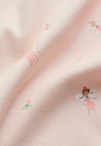 Šviesiai rožinė medžiaga su minkštu paviršiumi, puošta mažais gėlių raštais ir žaismingomis fėjų figūromis pastelinėmis spalvomis.