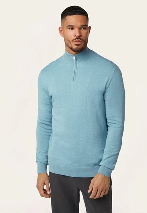 Light blue, long-sleeve sweater with a half-zip collar, ribbed cuffs, and hem. Made from a soft, textured fabric, fitted design.