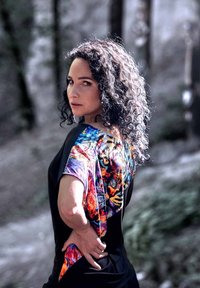 Colorful short-sleeve top featuring a black body and a vibrant animal print design on the sleeves. Soft fabric with a relaxed fit.