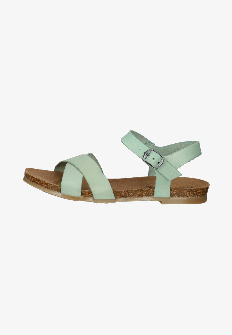 Groene leren sandalen met kruislings ontwerp, een enkelbandje aan de achterkant en een kurken zool. De zool is plat en doorzichtig aan de voorkant.