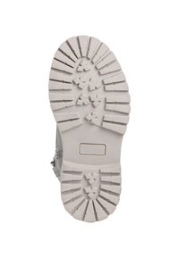 Sole of a footwear item; textured rubber in light gray with deep treads and angular patterns for grip. Flat, sturdy shape.