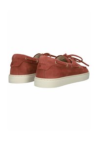 Pair of red suede moccasin-style shoes with white rubber soles and lace details viewed from the back and side on a white background.
