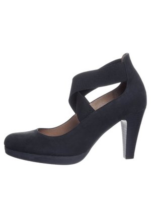 Czarne zamszowe buty na wysokim obcasie z paskiem wokół kostki i okrągłym noskiem. Posiadają teksturowany obcas oraz platformę, która dodaje wysokości.