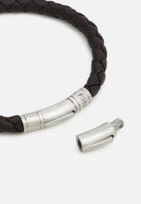 Black braided leather bracelet featuring silver metal accents, including a clasp with engraved details and a removable connector piece.