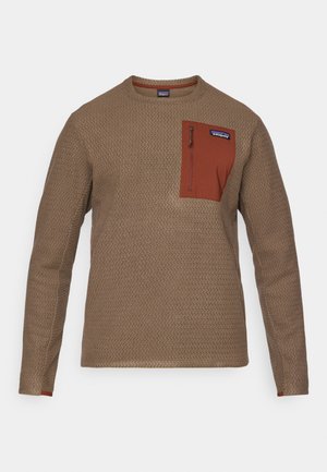 Brunet teksturert langermet skjorte med en mørk oransje brystlomme og glidelås, med rund hals og kontrasterende mansjett-detaljer.