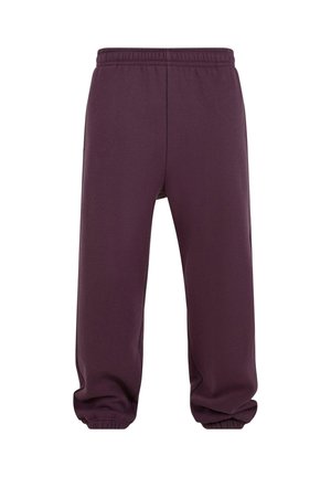 Lilla joggebukser laget av myk stoff, med elastisk midje, avsmalnende ben og ribbestrikkede mansjetter ved anklene.