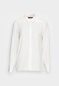 Blusa bianca a maniche lunghe in tessuto leggero con colletto classico, chiusura con bottoni e polsini leggermente arricciati. Texture morbida, design minimale.