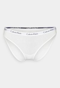 Hvite bomullsbikini-truser med et marineblått og hvitt Calvin Klein-logo på kanten. Har en glatt tekstur og et lavt liv.