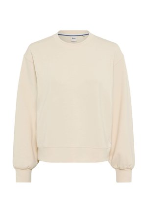 Sweatshirt beige clair, col rond, manches longues bouffantes, tissu texturé, coupe relaxe, avec une petite étiquette logo sur le côté inférieur.