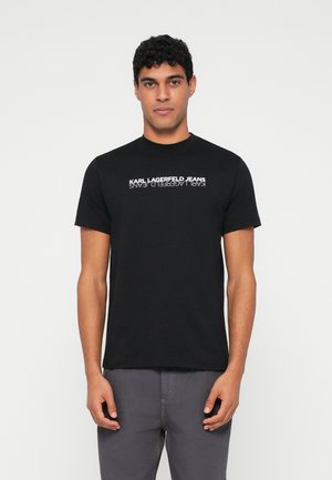 Must musta T-särk, millel on rinnal valgete tähtedega trükk "KARL LAGERFELD JEANS". Klassikaline ümar kaelus ja lühikesed varrukad.