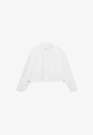 Weißes, kurzes Hemd mit langen Ärmeln, Knopfleiste und klassischem Kragen. Verfügt über einen seitlichen Akzent nahe dem Saum. Sanfte Stofftextur.