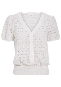 Blouse blanche à manches courtes avec un col en V, présentant un motif tricoté texturé, une fermeture à boutons à l'avant et un ourlet smocké élastique. Tissu léger.