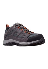 Scarpa da trekking grigia con tomaia in rete e suede, lacci arancioni, puntale in gomma e suola resistente progettata per avere trazione su vari terreni.