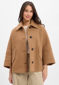 Brown wool blend jacket with a wide collar, button closure, and front pockets. Features a soft texture and loose, relaxed fit.