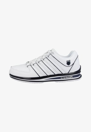 White athletic shoe with black accents, featuring synthetic material, six laces, and a prominent logo. Textured sole and padded collar.