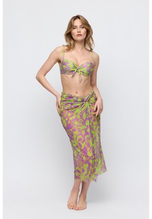 Bikini en doorschijnende wikkelset in paarse en groene bloemenprint, met een bandeautop met een geknoopt detail en een vloeiende, transparante rok.