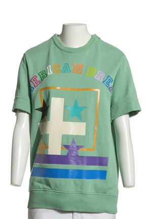 Sweat-shirt vert à manches courtes avec des lettres colorées formant le mot "AMERICAN DREAM" et des motifs géométriques d'étoiles et de rayures sur le devant.