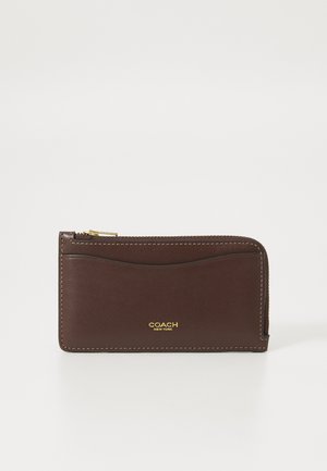 Brown leather wallet with a smooth texture, gold hardware detailing, zip closure, and embossed logo on the front. Compact rectangular shape.