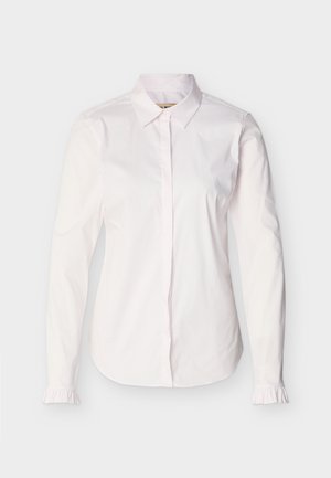 Λευκό γυναικείο πουκάμισο με μακριά μανίκια, μυτερό γιακά, κρυφά κουμπιά μπροστά και μικρές βολάν λεπτομέρειες στις μανσέτες.
