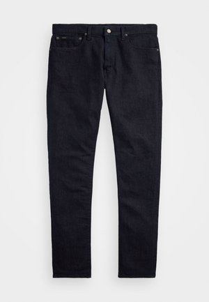 Pantalon en denim bleu foncé avec une coupe slim, un design à cinq poches et une fermeture à bouton en métal. Jambes droites et détails de couture minimalistes.