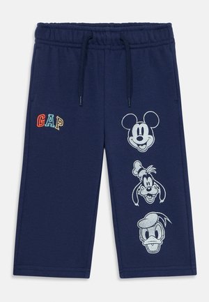 Dunkelblaue Kleinkind-Hosen mit Kordelzug, die bunten "GAP"-Schriftzug und weiße Umrisse von Mickey Mouse, Goofy und Donald Duck zeigen.