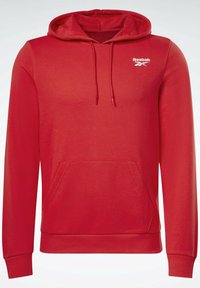 Sweat à capuche rouge avec poche kangourou, capuche avec cordon de serrage, logo Reebok sur la poitrine, et poignets et ourlet côtelés. Fabriqué en tissu doux et respirant.