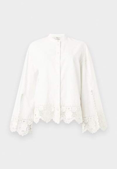 White long-sleeve button-up shirt with lace trim on cuffs and hem, featuring a mandarin collar and subtle decorative stitching.