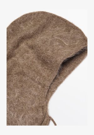 Primo piano di un morbido cappuccio in maglia marrone e peloso con un parziale cordoncino su uno sfondo bianco.