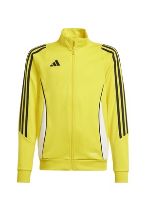 Geel sportjack met ritssluiting en zwarte strepen over de schouders en zijkanten, met een hoge kraag en witte accenten. Gemaakt van soepele stof.