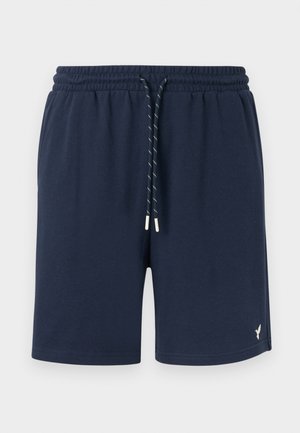 Shorts décontractés bleu marine avec ceinture élastique et cordon blanc, présentant un petit logo d'oiseau blanc sur la partie inférieure de la jambe gauche.