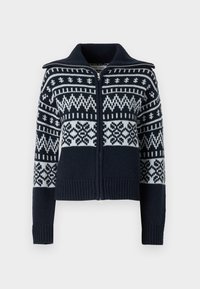 Námořnický pletený svetr s bílými geometrickými vzory, plný zip, krátký cropped styl, žebrované manžety a lem, a stojací límec.