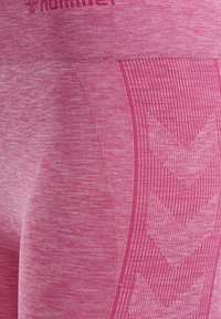 Růžové sportovní legíny s texturovaným, melírovaným vzorem. Mají hladkou látku, šikmý design s chevronovými akcenty a logo v pase.